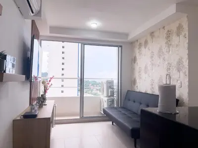 a living room with a couch and a large window at Family apartment in Cartagena 3 bedrooms 2 bathrooms in Cartagena de Indias