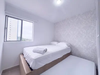 a white bedroom with a bed and a window at Family apartment in Cartagena 3 bedrooms 2 bathrooms in Cartagena de Indias