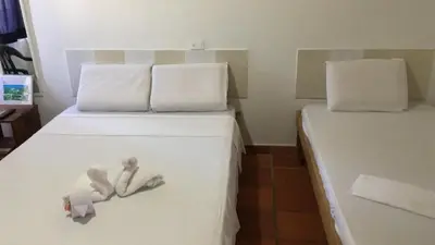 a bedroom with two beds with dolls on the bed at Hotel Pizzeria Opera Tolú in Tolú