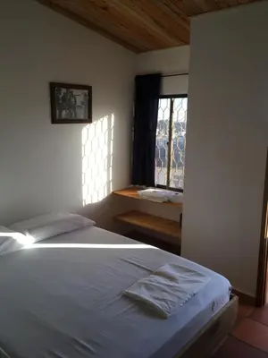 a bedroom with a large bed and a window at Hotel Pizzeria Opera Tolú in Tolú