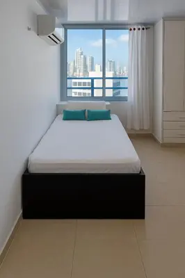 a large bed in a room with a large window at Tu Casa con Vista al Mar , Laguito-Bocagrande in Cartagena de Indias