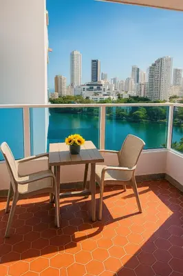 a table and chairs on a balcony with a view of the water at Tu Casa con Vista al Mar , Laguito-Bocagrande in Cartagena de Indias