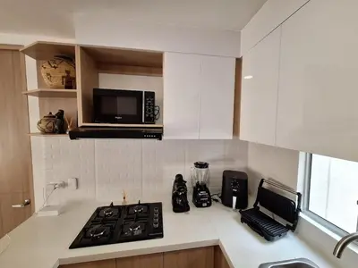 a kitchen with a stove and a microwave at Cartagena zona norte playa uso exclusivo in Cartagena de Indias