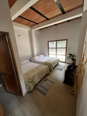 a bedroom with two beds and a wooden ceiling at Isla Rosa Coveñas in Coveñitas