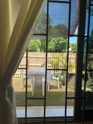 a view of a table and chairs through a window at Isla Rosa Coveñas in Coveñitas