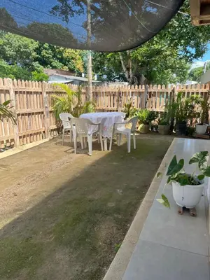 a table and chairs in a backyard with a fence at Isla Rosa Coveñas in Coveñitas