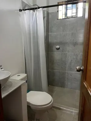 a bathroom with a shower and a toilet and a sink at Isla Rosa Coveñas in Coveñitas
