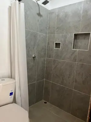 a bathroom with a shower with a toilet at Isla Rosa Coveñas - Alojamiento in Coveñitas