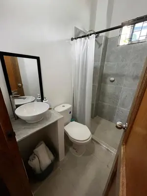 a bathroom with a toilet and a sink and a shower at Isla Rosa Coveñas - Alojamiento in Coveñitas