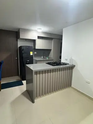 a kitchen with a stove and a black refrigerator at Apartamento moderno en zona norte exclusiva in Barranquilla