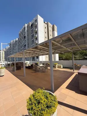 awning over a patio with tables and a building at Apartamento moderno en zona norte exclusiva in Barranquilla