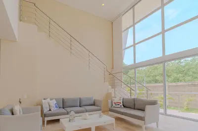 a living room with two couches and a large window at Casa Areia Frente Al Mar, Playa Privada in Playa Blanca