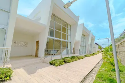 a large white building with a walkway at Casa Areia Frente Al Mar, Playa Privada in Playa Blanca