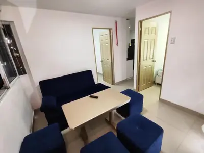 a room with a table and blue chairs and a mirror at Cozy 2nd Floor Apartment in Heart of Cartagena in Cartagena de Indias