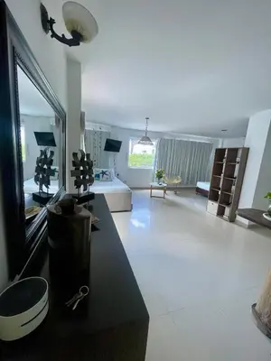 a large living room with a couch and a large mirror at Apartamento 201 frente a hotel Las américas in Cartagena de Indias