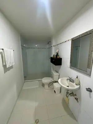 a white bathroom with a toilet and a sink at Cielo mar 202 frente a hotel Las Américas in Cartagena de Indias