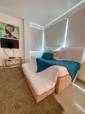 a bedroom with a bed and a television in it at Cielo mar 202 frente a hotel Las Américas in Cartagena de Indias