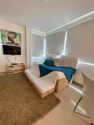 a bedroom with a bed and a tv in it at Cielo mar 202 frente a hotel Las Américas in Cartagena de Indias