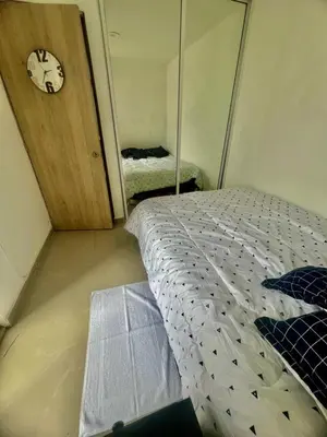 a bedroom with a bed and a clock on the wall at Moderno apartamento con vista al mar en Cartagena in Cartagena de Indias