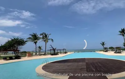 a swimming pool with a view of the ocean at Resort frente al mar in Juan de Acosta