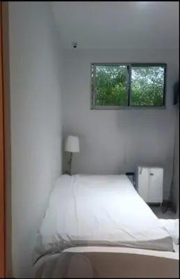 a white bed in a bedroom with a window at Resort frente al mar in Juan de Acosta