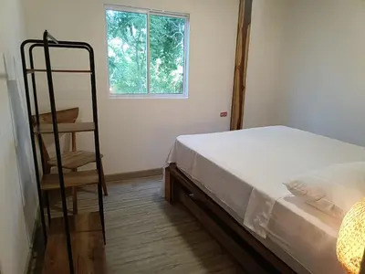 a bedroom with a bed and a ladder next to a window at Mar Barú Beach House in Playa Blanca