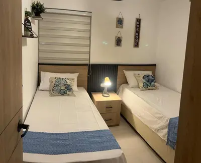 a bedroom with two beds and a night stand with a lamp at Beautiful apartment in Cartagena in Cartagena de Indias