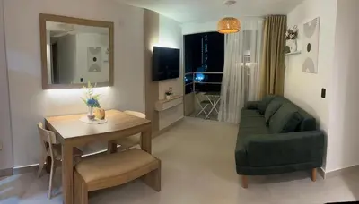 a living room with a table and a green couch at Beautiful apartment in Cartagena in Cartagena de Indias