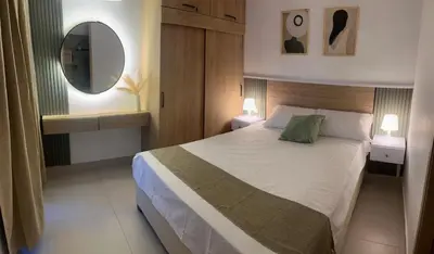 a bedroom with a large bed and a mirror at Beautiful apartment in Cartagena in Cartagena de Indias