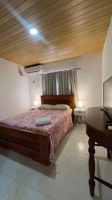 a bedroom with a bed and a table and a desk at Apartamento 6 pax in Estación El Salto