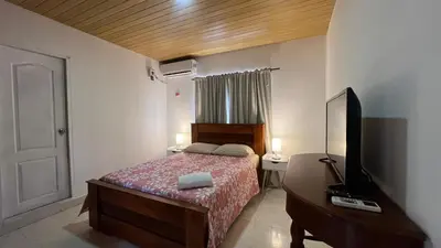 a bedroom with a bed and a desk with a television at Apartamento 6 pax in Estación El Salto