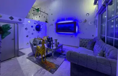 a purple living room with a couch and a table at Casa de lujo en Condominio Privado por Habitaciones in Cartagena de Indias