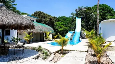 a resort with a water park with a slide at Villa del Atardecer Caribeño - JhonLimar in Bocachica