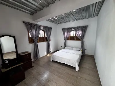a bedroom with a bed and a dresser and a mirror at Villa del Atardecer Caribeño - JhonLimar in Bocachica