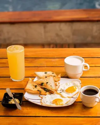 a plate of eggs and toast and a glass of orange juice at Hb-m8 House With 8 Bedrooms, Pool And Near The Sea in Cartagena de Indias