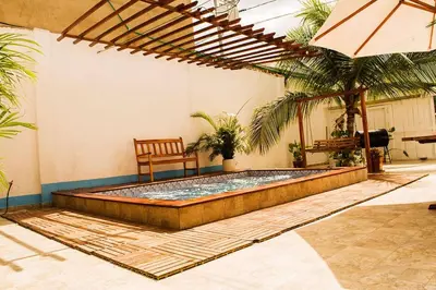 a swimming pool in a room with a chair at Hb-m8 House With 8 Bedrooms, Pool And Near The Sea in Cartagena de Indias