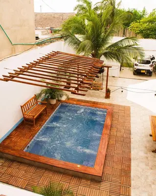 a swimming pool on the side of a building with a patio at Hb-m8 House With 8 Bedrooms, Pool And Near The Sea in Cartagena de Indias