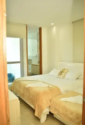 two beds in a room with a mirror at Magico Apartamento Frente al Mar 3 Habitaciones CV41 in Coveñitas