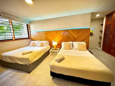 a bedroom with two beds and a window at Cartagena Vibes House in Cartagena de Indias