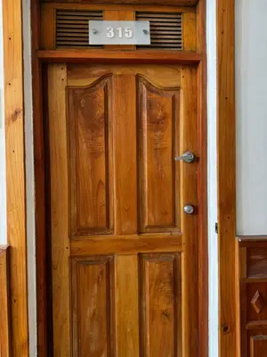 a wooden door with a clock on top of it at Luxury 2B Duplex in Old City Cartagena in Cartagena de Indias