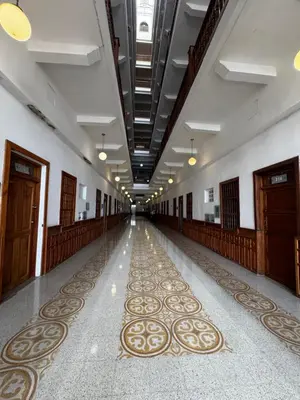 a hallway with a long aisle with wooden doors and carpet at Luxury 2B Duplex in Old City Cartagena in Cartagena de Indias