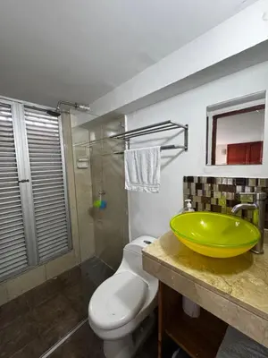 a bathroom with a green sink and a toilet at Luxury 2B Duplex in Old City Cartagena in Cartagena de Indias