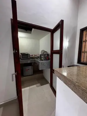 a room with a kitchen with a counter and a door at Luxury 2B Duplex in Old City Cartagena in Cartagena de Indias