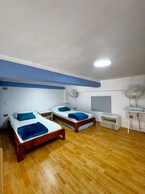 two beds in a room with wooden floors at Luxury Loft in Old City Cartagena - 5th in Cartagena de Indias