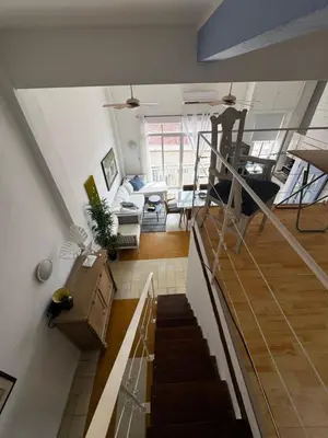 a room with a staircase and a living room at Luxury Loft in Old City Cartagena - 5th in Cartagena de Indias