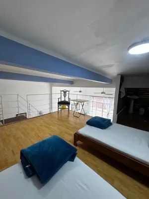 a room with two beds and a table in it at Luxury Loft in Old City Cartagena - 5th in Cartagena de Indias