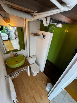 a bathroom with a green sink and a toilet at Luxury Loft in Old City Cartagena - 5th in Cartagena de Indias
