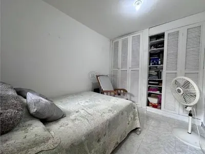 a white bedroom with a bed and a fan at Apartamento Pie de la Popa Cartagena - 3 Habitaciones in Cartagena de Indias