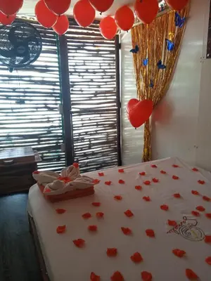 a bedroom with red hearts and balloons on a bed at Venido del mar III in Playa Blanca