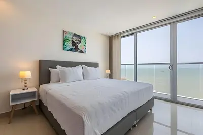 a bedroom with a large bed with a large window at 1004 Morros City - Spectacular 1 Bedroom Condo in Cartagena de Indias